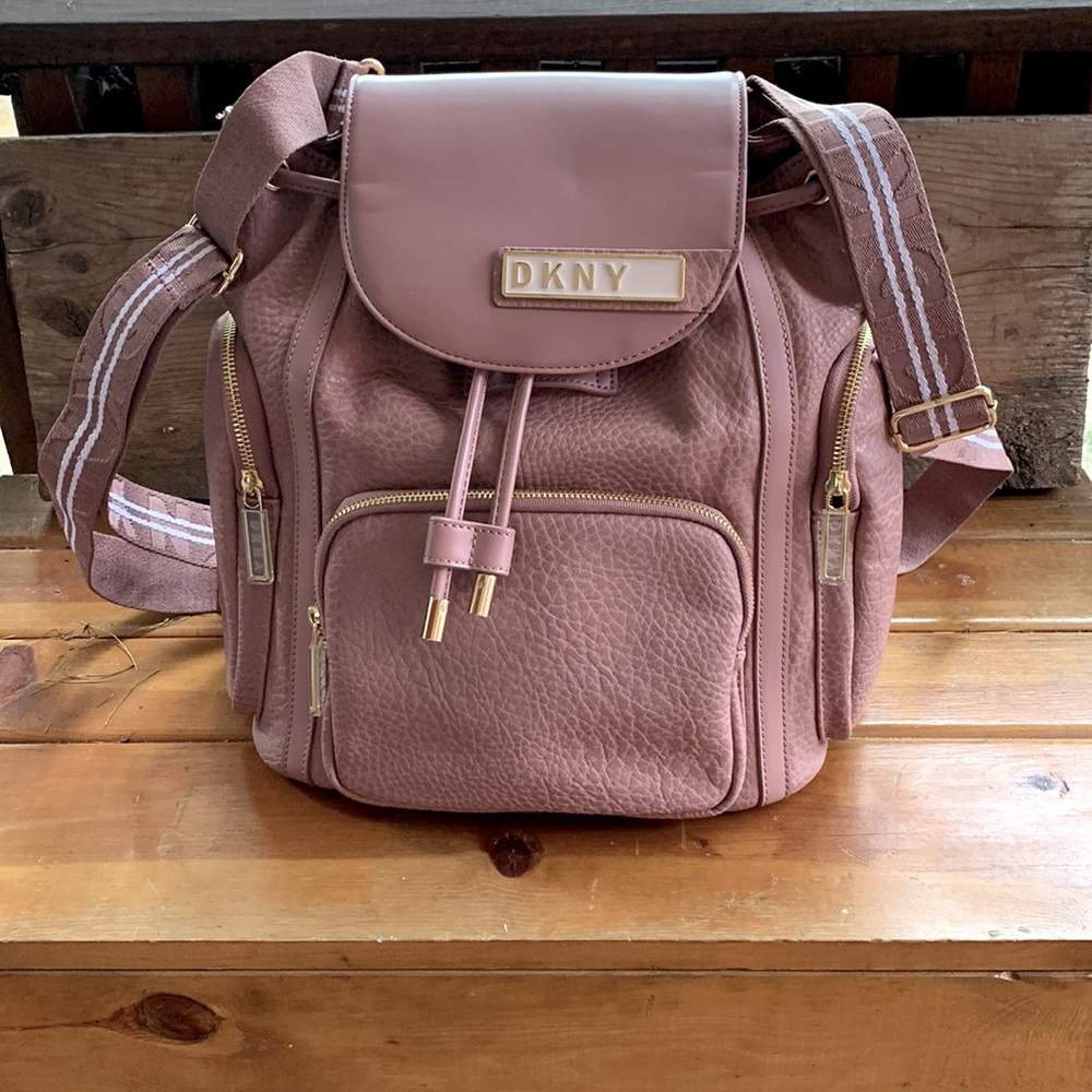 DKNY backpack, red inside, A+ condition, gold embellishments.